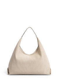 Sac à épaule en daim beige et doux, avec une grande silhouette arrondie et une seule anse ronde, présentant un détail de couture à l'avant.
