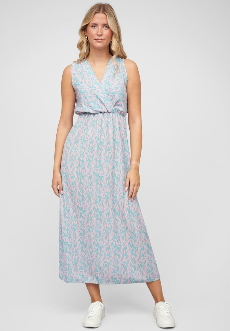 Maxime dress in light blue with pink abstract pattern, sleeveless design, v-neckline, gathered waist, soft texture, paired with white sneakers.