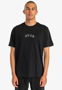 Black cotton T-shirt featuring a crew neckline and short sleeves. It has a stylized "RVCA" logo in gray on the chest.