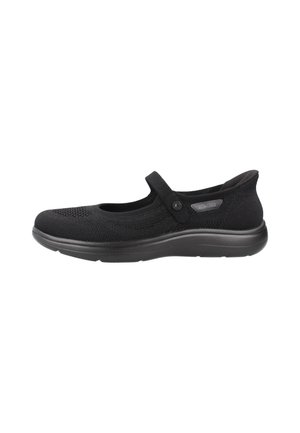 Black Mary Jane-style slip-on shoe with textured fabric upper, single strap with button, and cushioned sole for comfort and support.