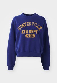 Sweatshirt azul marinho com gola redonda canelada, mangas compridas e barra corta. Apresenta texto em amarelo desgastado com a inscrição "STATESVILLE ATH DEPT. 431".