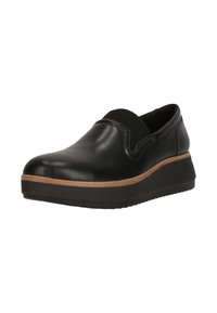 Chaussure noire en cuir à enfiler avec une semelle basse, présentant une bande d'accent en cuir beige, des panneaux latéraux en élastique et une semelle en caoutchouc texturée.