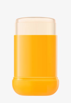 Żółty sztyft do opalania z zdjętym korkiem, ukazujący wewnątrz stały, przezroczysty filtr przeciwsłoneczny na białym tle.