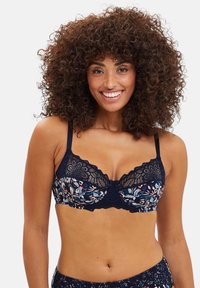 Marine bloemen kanten bh met beugel en golvende randen. Bevat bloemenprintcups, verstelbare bandjes en een decoratieve strik in het midden.