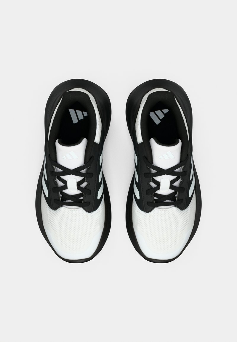 Zapatillas deportivas blancas y negras con parte superior de malla, suela de goma y tres franjas blancas en los lados. Diseño con cordones y interior acolchado.