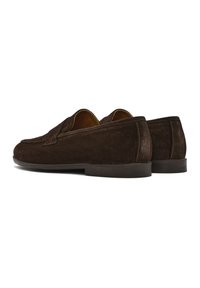 Brown suede loafers with a rounded toe and low rubber sole, featuring clean lines and minimal stitching for a clean silhouette.