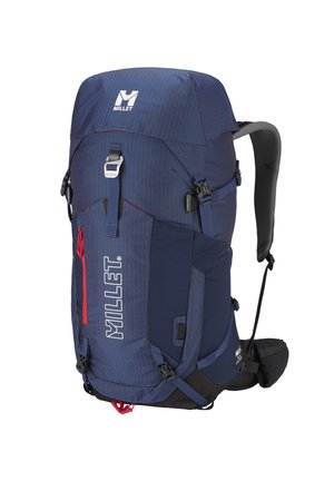 Dark blue Millet hiking backpack with multiple straps, side mesh pockets, padded shoulder and waist straps, and a red front zipper pocket.