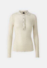 Ribbete langermet polo genser i lys beige med kragehals og seks metallknapper foran. Myk tekstur med en subtil glans.
