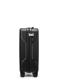 Black hard-shell suitcase with a ridged design, dual zippers, built-in combination lock, and four swivel wheels for mobility.
