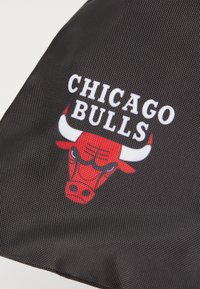 Black fabric featuring the Chicago Bulls logo. The logo includes a red bull's head with white horns and black accents, above the text "CHICAGO BULLS."
