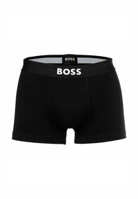 Schwarze Boxershorts aus weichem Stoff mit einem elastischen Bündchen, das "BOSS" in weißer Schrift zeigt. Klassische Passform mit einem konturierten Einschub.