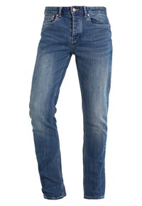 Modré džíny z denimu s úzkým střihem, pěti kapsami a jemným vyblednutím. Mají zapínání na knoflíky a zip s měděnými detaily.