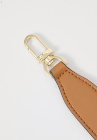 Brown leather strap with a smooth texture, featuring gold-tone metal hardware for attaching. Clean design with contrasting stitching detail.