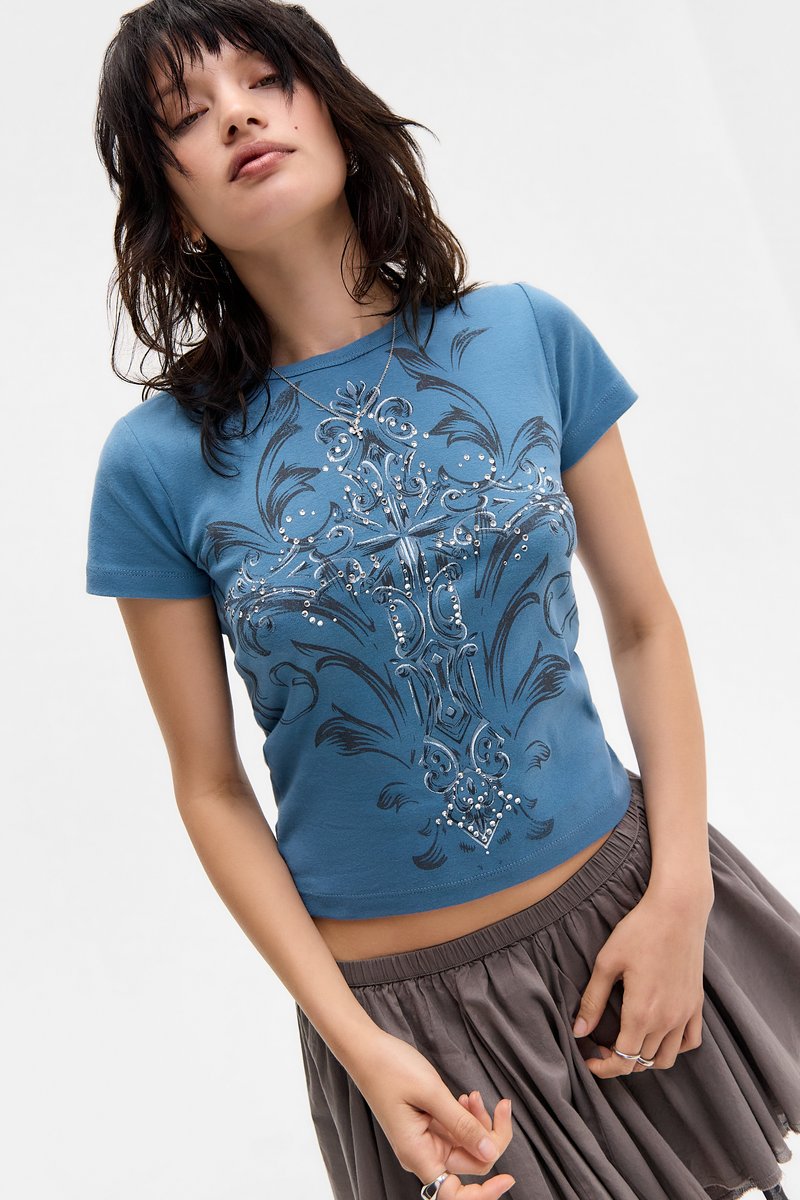 Blue short-sleeve cotton t-shirt with a decorative black and silver graphic design featuring swirls and rhinestone accents.