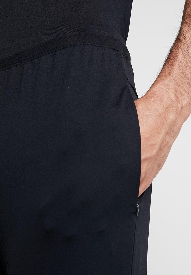 Herren Sportbekleidung | Under Armour RUSH ENGANLIEGEND Jogginghose black/schwarz - PK27492 Herren Sportbekleidung | Under Armour RUSH ENGANLIEGEND Jogginghose black/schwarz - PK27492