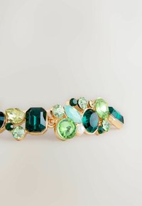 Gold-tone jewelry piece featuring clusters of green, turquoise, and light yellow gemstones in various shapes and sizes. Pearl accent included.