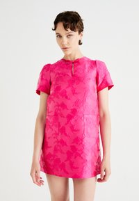 Short-sleeve pink dress with embossed floral pattern. Features a round neckline, keyhole closure, and two patch pockets on the front.