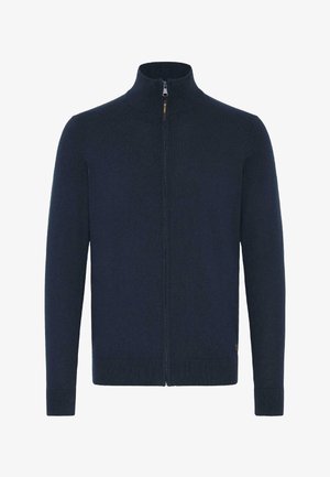 Sudadera de cremallera en azul marino oscuro con un cuello alto, fabricada en suave tejido de punto, que presenta puños y dobladillo acanalados para un ajuste ceñido.