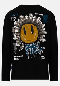 Schwarzes Langarmshirt mit einem großen grafischen Motiv einer lächelnden Sonnenblume mit einem braunen Gesicht, begleitet von blauen und weißen Textelementen.