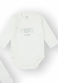 Body blanco de manga larga con frente cruzado, presenta un gráfico de tres animales de dibujos animados y texto "y amigos". Cierre de botones a presión en la parte inferior.