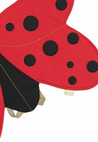 Red fabric item shaped like a ladybug, featuring black spots, black wings, and a gold-accented strap. Reinforced seams and smooth texture.