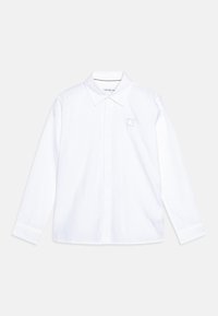 Camicia bianca a maniche lunghe in cotone con colletto classico, dotata di una piccola etichetta con il logo Calvin Klein sul petto.