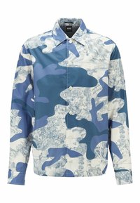 Pitkähihaisessa napitettavassa paidassa on sinivalkoinen abstrakti kamouflage- ja maalaismaisemakuosi. Paidassa on terävä kaulus ja hihansuut, jotka on käännetty.