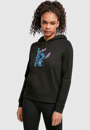 Black hoodie made of cotton blend, featuring a graphic of a blue cartoon character and the word "STITCH" in bold letters. Front pocket included.