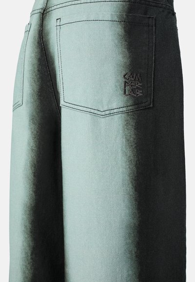 Džínové kalhoty s přechodem ze zelené do černé barvy, dvěma zadními kapsami a vyšitým logem. Pevný materiál, hladká textura a čisté linie.