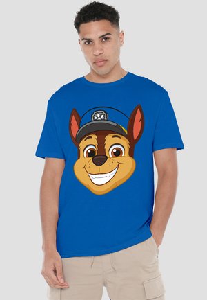Royal blue t-shirt featuring a large cartoon dog face design with a cap, showcasing vibrant colors and bold outlines. Short sleeves.