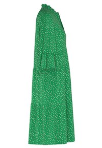 Zelené šaty s vrstveným designem, zdobené krémovým puntíkovým vzorem, s rýhovaným výstřihem a rozšířenými rukávy. Hladká textilie.