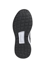 Suela de zapato de goma negra con patrón de agarre texturizado, acentos en blanco y un área central elevada. Presenta tracciones en espiga y rectangulares.