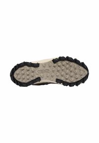 Suola di scarpa in gomma nera e beige con un motivo di grip testurizzato, caratterizzata da lobbia triangolari e un logo centrale con la parola "Columbia."