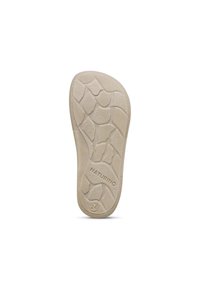Podešev boty, béžový gumový materiál, texturovaný vzory připomínajícími kameny, s zaobleným okrajem a embosovaným logem "NATURINO".