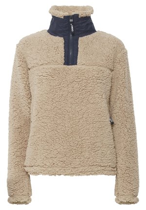Beige fleece pullover met een rits van een kwart lengte, hoge kraag en een marineblauw paneel aan de bovenkant van de voorkant, met een gestructureerde, zachte stof.