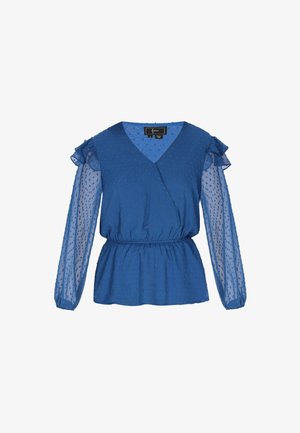 Kék blúz texturált pöttyökkel, mély V-nyakkal és áttetsző puffujjakkal, fodros részletekkel. Elasztikus derék a formás siluettért.