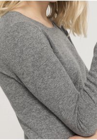 Grey knitted sweater with a smooth texture, round neckline, and long sleeves. Features ribbed detailing on cuffs and body.