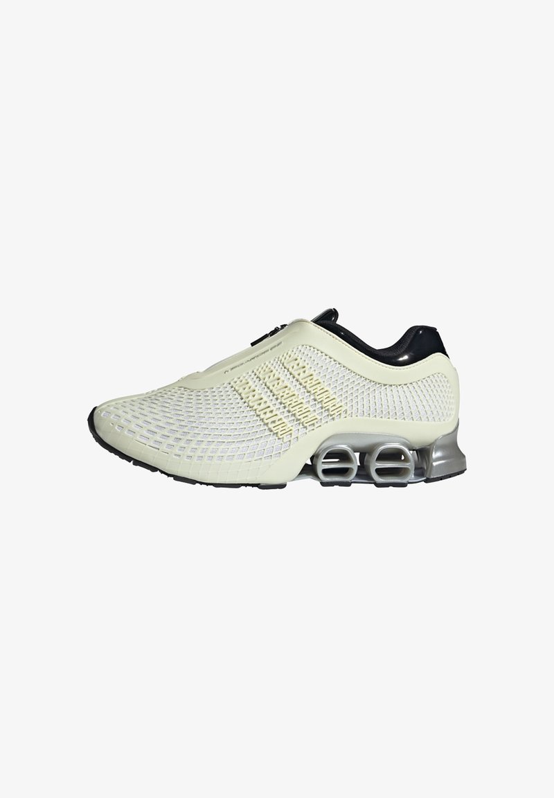 Hvid mesh sportsko med en tekstureret overdel, sorte accenter og ikonisk sølvfarvet fjederlignende polstret sål. Har en lynlås lukning.