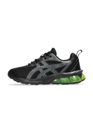 Baskets de sport noires avec une tige en mesh, des accents gris et une semelle à bulles verte. Présente une forme arrondie et un système de laçage.