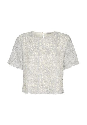 Blouse en dentelle blanche avec un motif floral, manches courtes et encolure ronde avec une fermeture à bouton à l'arrière. Design texturé.