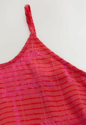 Rdeča brezrokavnik s verticalnimi črtami v različnih odtenkih roza, narejena iz lahkega materiala. Ima tanke nastavljive naramnice.