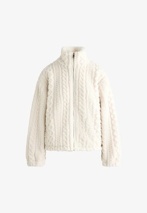 Fleeceová bunda v svetlo-bielej farbe s vysokým golierom, zipsovým uzáverom a vystúpenou štruktúrou pletenia. Obsahuje spadnuté ramená a elastické manžety.