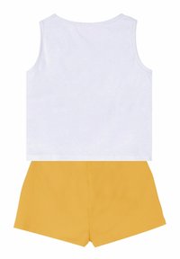 White sleeveless top paired with yellow shorts. The top features a round neckline, while the shorts are short and solid-colored.