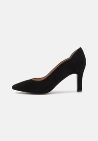 Black suede high heel shoe with a pointed toe, slender heel, and a smooth inner lining. Features a curved silhouette and subtle texture.