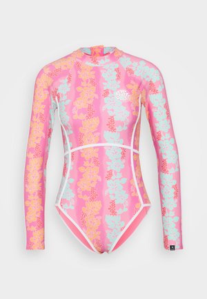 Long-sleeve pink surf suit with a floral pattern in orange and teal, featuring white accents and a round logo on the chest.