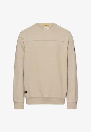 Beige Sweatshirt mit Rundhalsausschnitt und langen Ärmeln, gerippte Bündchen und Saum, kleines schwarzes Markenetikett in der Nähe des Saums und Detail am Ärmelpatch.