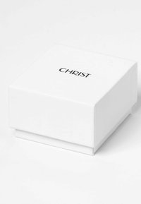 Vit rektangulär presentlåda med en slät yta, prydd med en svart tryckt "CHRIST"-logotyp på ovansidan.