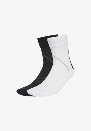 Black and white ankle socks made of a thin, textured material, featuring a contrasting grey pattern on the black sock and a smooth finish.