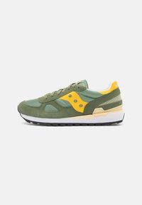 Green suede and mesh sneaker with yellow accents, laces, and logo; features a white midsole and black rubber outsole.