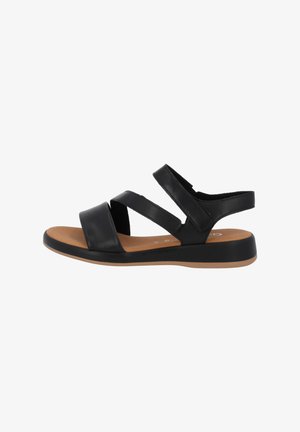 Black leather sandals featuring two wide cross straps and back strap, with a cushioned tan footbed and black rubber sole.